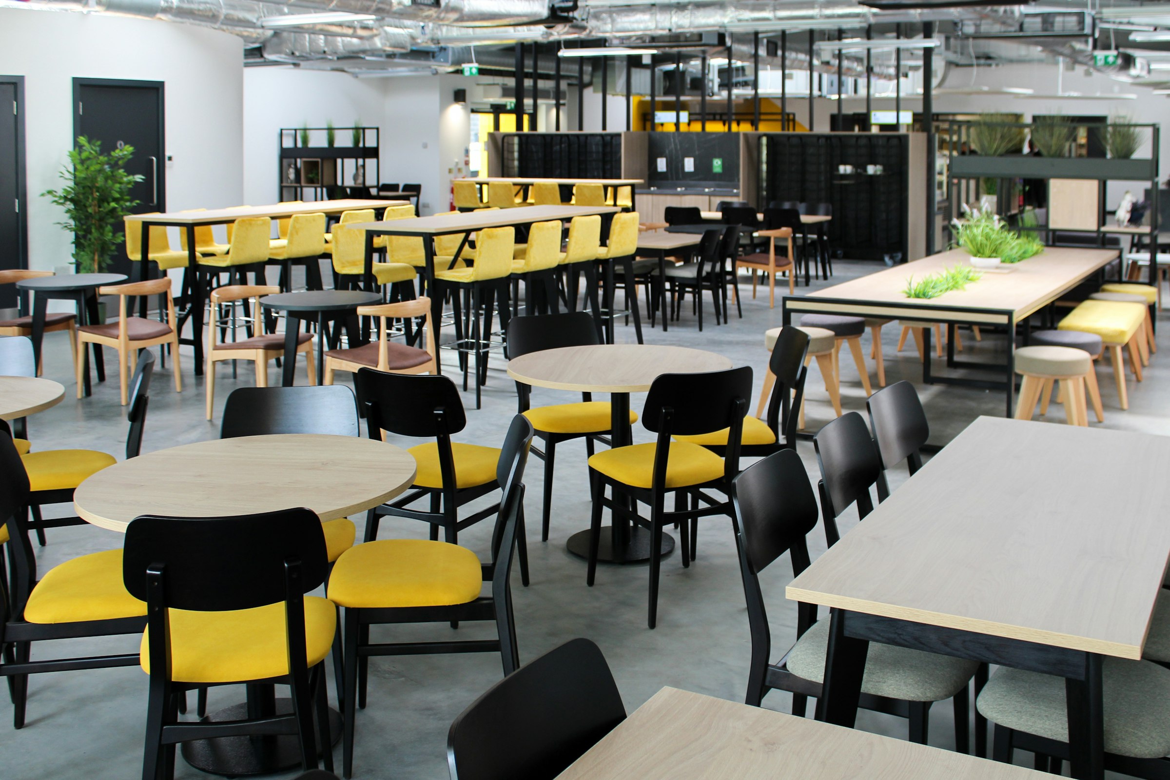 Bright workplace cafeteria with clean floors and dining tables